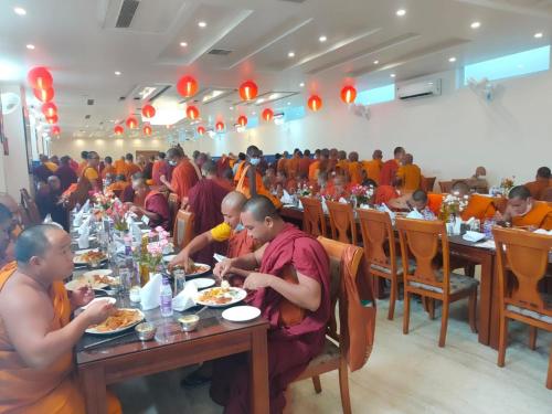 a group of people sitting at tables eating food at HOTEL ANAND INTERNATIONAL in Bodh Gaya