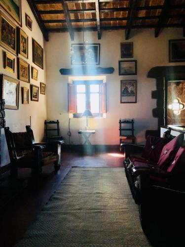 a living room with couches and a window at Hosteria Fortin de San Miguel in Chuy