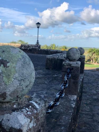 a chain is tied to a stone wall with rocks at Hosteria Fortin de San Miguel in Chuy