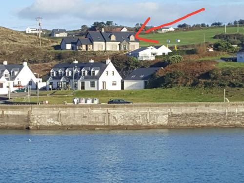 a red arrow points to a town next to a body of water at The LookOut in Skibbereen