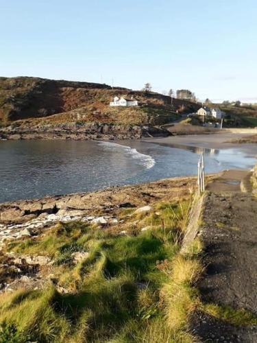 a body of water with a beach with a house at The LookOut in Skibbereen