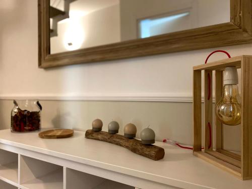 a bathroom counter with a mirror and a sink at Foresteria Green House 1 in Seriate