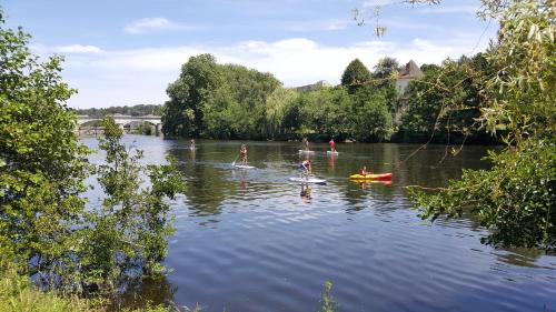 a group of people in the water on a river at La Vieille Gorce Gîtes in the Vienne in Asnois