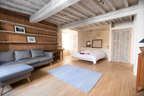 un salon avec un canapé et un lit dans l'établissement Perchoir - Terrasse, à Arles