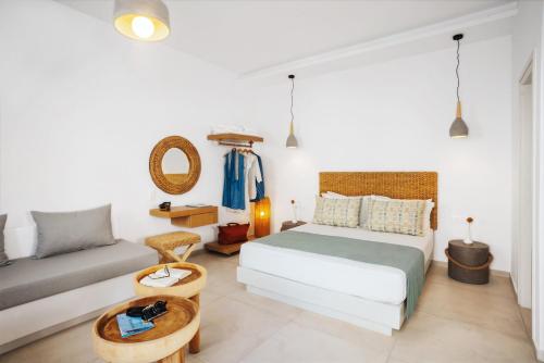 a bedroom with a bed and a couch at Andromeda Residences in Astypalaia Town