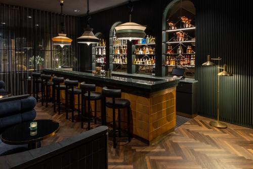 a bar in a restaurant with stools at Hotel ROMY by AMANO in Berlin