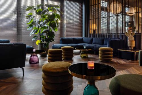 ein Wohnzimmer mit einem Sofa und einem Tisch in der Unterkunft Hotel ROMY by AMANO in Berlin
