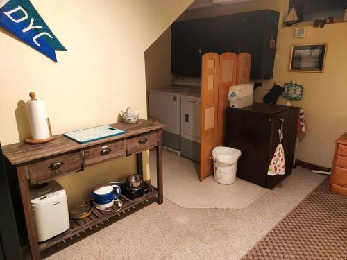 a kitchen with a wooden table and a refrigerator at Swan Mountain View-Private Basement Suite/10 acres in Kalispell