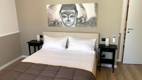a bedroom with a bed with two night stands at Foresteria Green House 1 in Seriate