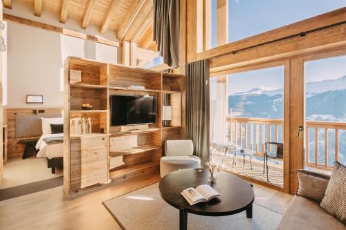 a living room with a view of a mountain at Eringer Hotel in Hérémence