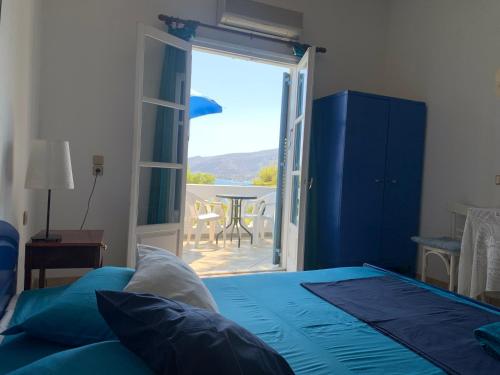 a bedroom with a bed and a door to a patio at Apartment Villa Loula in Poros