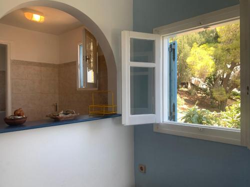 an open window in a bathroom with a sink at Apartment Villa Loula in Poros