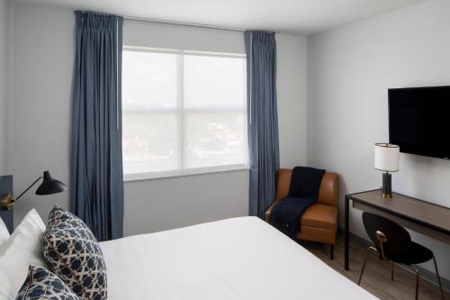 a hotel room with a bed and a window at Generator Miami in Miami Beach