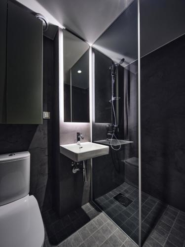 a bathroom with a sink and a shower and a toilet at Campus House by Larsen in Tallinn