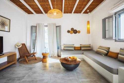 a living room with a couch and a table at Andromeda Residences in Astypalaia Town