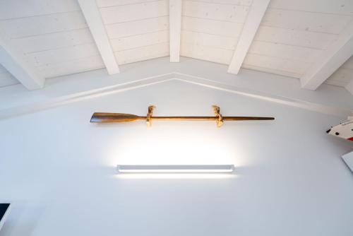 two swords hanging from the ceiling of a room at La Retara Affittacamere in San Benedetto del Tronto