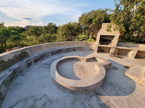a concrete skate park with a bench and a table at Livingstone Bush Lodge, Mabalingwe in Bela-Bela