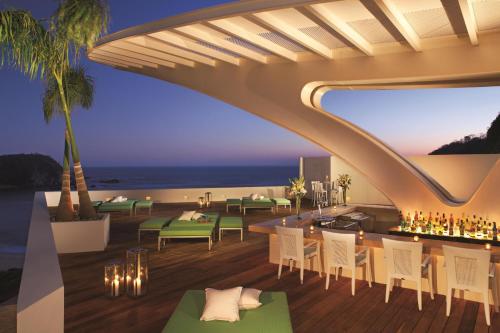 a rendering of a restaurant with a view of the beach at Secrets Huatulco Resort & Spa in Santa Cruz Huatulco