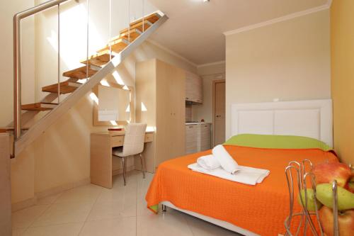 a small room with a bed and a staircase at Mavridis Rooms 2 in Nikiti