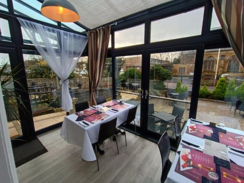 紹斯波特的住宿－公爵富麗大酒店，一间带桌子和一些窗户的用餐室