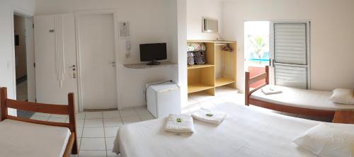 Ένα ή περισσότερα κρεβάτια σε δωμάτιο στο HOTEL CLUBE AZUL DO MAR