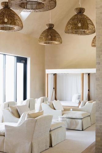 a living room with white couches and large windows at Inns of Aurora Resort & Spa in Aurora