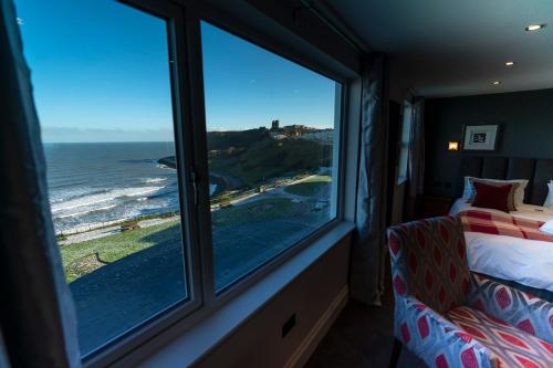 a room with a window with a view of the ocean at The Helaina in Scarborough