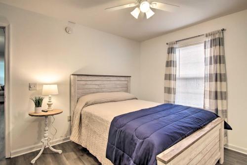 a bedroom with a bed and a table and a window at Pool Access and Fire Pit Ocean Pines Retreat! in Ocean Pines