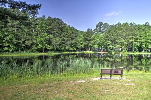 a park bench sitting in front of a lake at Pool Access and Fire Pit Ocean Pines Retreat! in Ocean Pines