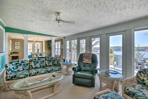 a living room with a couch and a table and chairs at Unique Camden Waterfront with Spectacular Views! in Camden