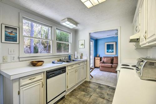 a kitchen with white cabinets and a sink and a window at Unique Camden Waterfront with Spectacular Views! in Camden