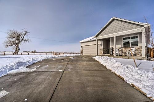 a house with snow on the side of a road at Dreamy Windsor Home with Grill about 3 Miles to Lake! in Windsor