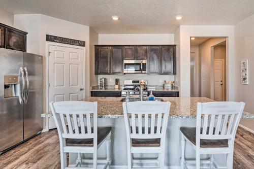 a kitchen with white chairs and a counter top at Dreamy Windsor Home with Grill about 3 Miles to Lake! in Windsor