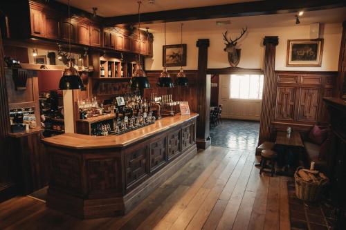 a bar in a room with wooden floors and wooden cabinets at The Swan Hotel in Newport