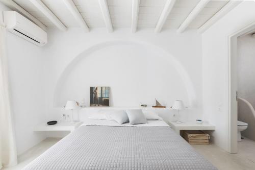 a white bedroom with a bed and white walls at Mesmerizing 5bed Villa with Pool in Kanalia in Agios Ioannis Mykonos