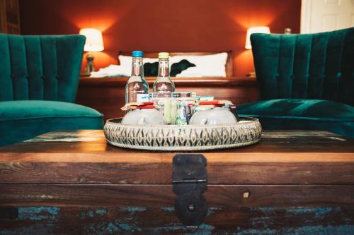 a tray with bottles and glasses on top of a table at The Swan Hotel in Newport