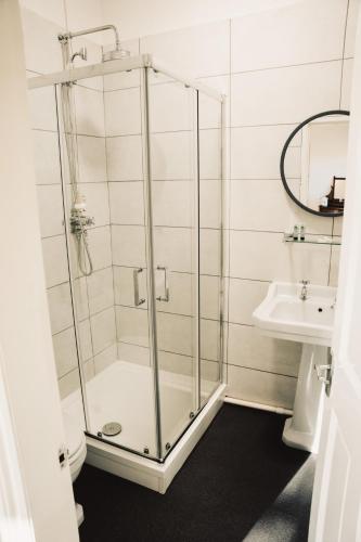 a glass shower in a bathroom with a sink at The Swan Hotel in Newport