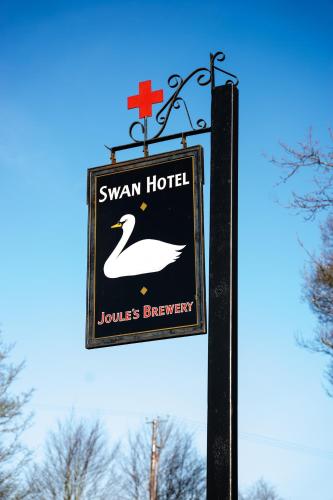 a sign for a swan hotel with a swan at The Swan Hotel in Newport