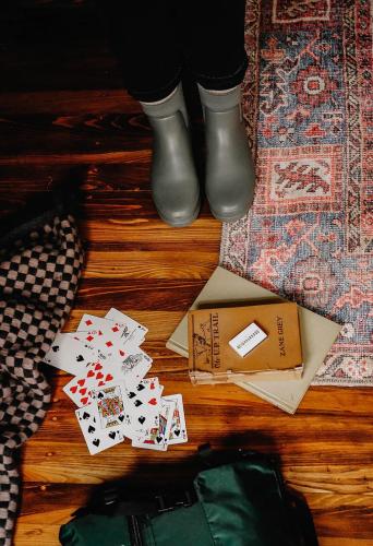 a person in boots and playing cards on the floor at The Neighborhood Hotel Grand Beach in New Buffalo
