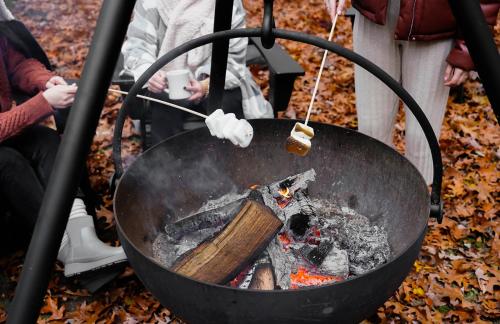 a person cooking over a fire in a wok at The Neighborhood Hotel Grand Beach in New Buffalo