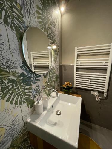a bathroom with a white sink and a mirror at Casa Vacanze Gramsci in Marsala