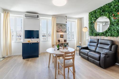 a living room with a couch and a table at Aurora Lov'Room Proche de Saint Charles in Marseille