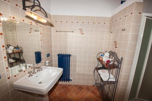 a bathroom with a sink and a shower at Il Borgo Del Lupo Relax Family Apartments in Tuscany with Restaurant & Swimming Pool in Sarteano
