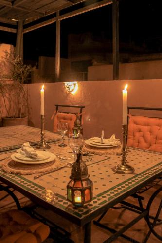 a table with two candles on top of it at Riad Dar Habiba by Garden Wonders in Marrakech