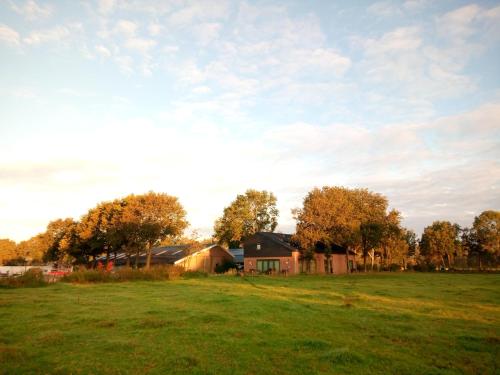 a house in the middle of a field at B&B In de Wei in Erp