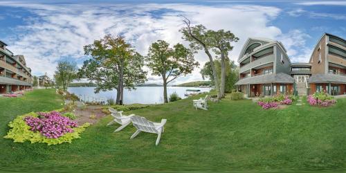 a building with a yard with benches and flowers at Mill Falls Resort Collection at the Lake in Meredith