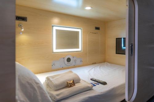 a hotel room with a bed and a television at HosteLit, Capsule Hostel in Santa Cruz de la Palma