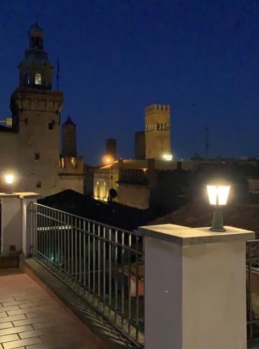 a light sitting on a ledge on a balcony at night at Hotel Roma in Bologna