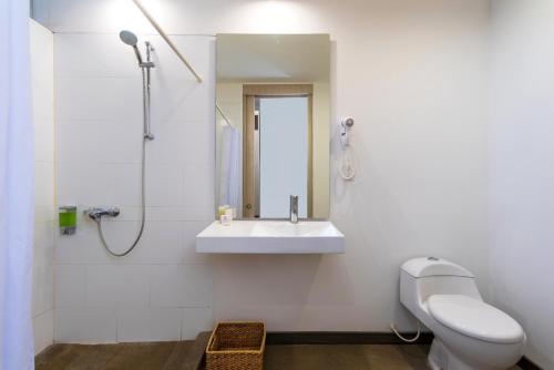 a bathroom with a sink and a toilet and a mirror at Pop Art Hotel CLC Mamonal Cartagena in Cartagena de Indias