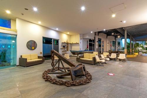 a living room with couches and a pool table at Pop Art Hotel CLC Puerto Mamonal Cartagena in Cartagena de Indias